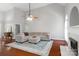 Spacious living room showcasing hardwood floors, a cozy seating arrangement, and ample natural light at 4605 Sarandon Ct, Charlotte, NC 28215
