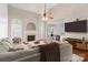 Comfortable living room featuring a fireplace, hardwood floors, and seamless flow to the dining area at 4605 Sarandon Ct, Charlotte, NC 28215