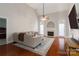 Inviting living room with vaulted ceiling, fireplace, hardwood floors, and abundant natural light at 4605 Sarandon Ct, Charlotte, NC 28215