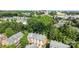 A bird's eye view of a townhome community with lush greenery and the city skyline visible in the distance at 4854 S Hill View Dr, Charlotte, NC 28210