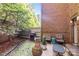 Enclosed courtyard with brick walls, patio furniture, and lush greenery for private outdoor relaxation at 4854 S Hill View Dr, Charlotte, NC 28210