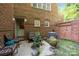 Private courtyard featuring brick walls, comfortable seating, potted plants, and an air conditioner at 4854 S Hill View Dr, Charlotte, NC 28210