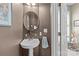 Powder room with a decorative mirror, pedestal sink, neutral paint and an adjacent doorway at 4854 S Hill View Dr, Charlotte, NC 28210