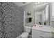Bathroom featuring a zebra shower curtain, toilet, sink, mirror, and tile flooring at 4854 S Hill View Dr, Charlotte, NC 28210