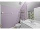 Cozy bathroom with purple walls featuring a toilet, sink and mirror at 4854 S Hill View Dr, Charlotte, NC 28210