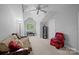 Bright bedroom with vaulted ceiling, fan, and a window offering natural light at 4854 S Hill View Dr, Charlotte, NC 28210