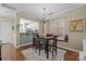 Cozy dining room with hardwood floors, natural light from large windows, and easy kitchen access at 4854 S Hill View Dr, Charlotte, NC 28210