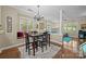 Elegant dining area with hardwood floors, chandelier, and natural light from large windows at 4854 S Hill View Dr, Charlotte, NC 28210