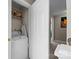 Compact laundry room with a washing machine and storage shelves at 4854 S Hill View Dr, Charlotte, NC 28210