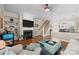 Spacious living room showcasing hardwood floors, a fireplace, and staircase access at 4854 S Hill View Dr, Charlotte, NC 28210
