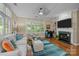 Bright living room showcasing hardwood floors, fireplace, built-in shelves, and abundant natural light at 4854 S Hill View Dr, Charlotte, NC 28210