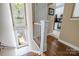 Inviting stairway leading to a bright, sunlit landing and a glimpse of the adjacent kitchen at 4854 S Hill View Dr, Charlotte, NC 28210
