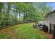 Spacious fenced backyard featuring a patio area with outdoor seating, mature trees, and ample green space at 4921 Sierra Dr, Maiden, NC 28650