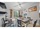 Cozy dining room featuring a ceiling fan, a table set for four, and access to the backyard at 4921 Sierra Dr, Maiden, NC 28650