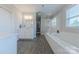 Elegant bathroom with double vanity, a soaking tub, and glass-enclosed shower, creating a spa-like experience at 5256 Meadowcroft Way, Fort Mill, SC 29708