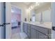 Bathroom with double sink vanity featuring gray cabinetry and a white countertop, bedroom view at 5256 Meadowcroft Way, Fort Mill, SC 29708
