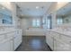 Bright bathroom with dual sinks, a large soaking tub, and walk-in shower perfect for relaxation at 5256 Meadowcroft Way, Fort Mill, SC 29708