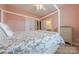 Bright bedroom features a four-poster bed, neutral carpet and an ensuite bath and closets at 5256 Meadowcroft Way, Fort Mill, SC 29708