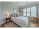 Cozy bedroom with natural lighting, neutral decor, and hardwood flooring at 5256 Meadowcroft Way, Fort Mill, SC 29708