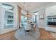 Bright dining area with modern chandelier, hardwood floors, and backyard views at 5256 Meadowcroft Way, Fort Mill, SC 29708