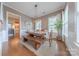 Dining room with a wooden table, bench, and chairs with views of the bathroom at 5256 Meadowcroft Way, Fort Mill, SC 29708