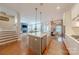 Open-concept kitchen with hardwood floors, large island, and stainless steel appliances at 5256 Meadowcroft Way, Fort Mill, SC 29708