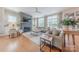 Bright and airy living room featuring a fireplace, hardwood floors, and large windows at 5256 Meadowcroft Way, Fort Mill, SC 29708