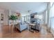 Cozy living room featuring hardwood floors, a fireplace, comfortable seating, and bright natural light at 5256 Meadowcroft Way, Fort Mill, SC 29708