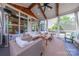 Inviting sunroom with white paneled walls, beamed ceiling, cozy seating, and a view of the patio at 5256 Meadowcroft Way, Fort Mill, SC 29708
