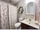 The cozy bathroom features a floral shower curtain, vanity with sink, and an ornate mirror at 5434 Starflower Dr, Charlotte, NC 28215