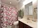 Cozy bathroom with floral shower curtain, vanity with sink, and mirror with floral decor at 5434 Starflower Dr, Charlotte, NC 28215