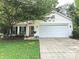 Inviting home with a well-maintained lawn, mature trees, and a two-car garage enhancing curb appeal at 5434 Starflower Dr, Charlotte, NC 28215