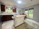Well-lit kitchen with wood cabinetry, an island, and a cozy dining nook perfect for Gathering meals at 5434 Starflower Dr, Charlotte, NC 28215