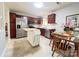 Functional kitchen featuring stainless appliances, dark wood cabinets, and an island offering extra counter space at 5434 Starflower Dr, Charlotte, NC 28215