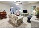 Cozy living area with a floral sofa, wood desk, and access to the adjacent kitchen providing seamless flow at 5434 Starflower Dr, Charlotte, NC 28215