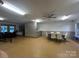 Bright recreation room with a ceiling fan, multiple tables, and a bar near the pool area at 5434 Starflower Dr, Charlotte, NC 28215