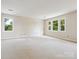 Bright bedroom featuring carpeting and multiple windows offering plenty of natural light at 5632 Zion Church Rd, Concord, NC 28025