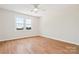 Bright bedroom featuring hardwood floors, large window and a ceiling fan at 5632 Zion Church Rd, Concord, NC 28025