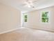 Neutral bedroom featuring carpeted floors, ample natural light, and closet at 5632 Zion Church Rd, Concord, NC 28025