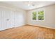 Charming bedroom featuring hardwood floors, closet, a window and a ceiling fan at 5632 Zion Church Rd, Concord, NC 28025