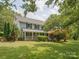 Traditional home featuring a covered front porch, well-kept lawn, and lush landscaping at 5632 Zion Church Rd, Concord, NC 28025