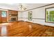 Spacious living room with beautiful hardwood floors, brick fireplace and natural lighting at 5632 Zion Church Rd, Concord, NC 28025
