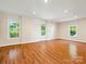 Bright and airy room featuring hardwood floors, recessed lighting, and multiple windows at 5632 Zion Church Rd, Concord, NC 28025