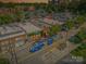 Aerial shot of a commercial district featuring a JWU trolley and diverse shops, showcasing vibrant urban connectivity at 622 Mattie Rose Ln, Charlotte, NC 28204