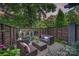 Charming backyard patio featuring woven furniture, brick pavers, garden, and privacy fence, perfect for outdoor entertaining at 622 Mattie Rose Ln, Charlotte, NC 28204