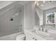 Modern bathroom featuring a tub with glass enclosure, a vanity, and a window at 622 Mattie Rose Ln, Charlotte, NC 28204