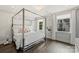 Stylish bedroom featuring a four poster bed, natural lighting, and dark hardwood flooring at 622 Mattie Rose Ln, Charlotte, NC 28204