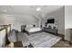 Neutral bedroom with grey walls, bed, a ceiling fan, and decorative sports accessories at 622 Mattie Rose Ln, Charlotte, NC 28204