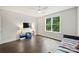 Bright bedroom with natural light from a large window, plus a ceiling fan and hardwood floors at 622 Mattie Rose Ln, Charlotte, NC 28204