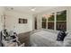 Bright bedroom with a back yard view, seating area, hardwood floors, and neutral decor at 622 Mattie Rose Ln, Charlotte, NC 28204